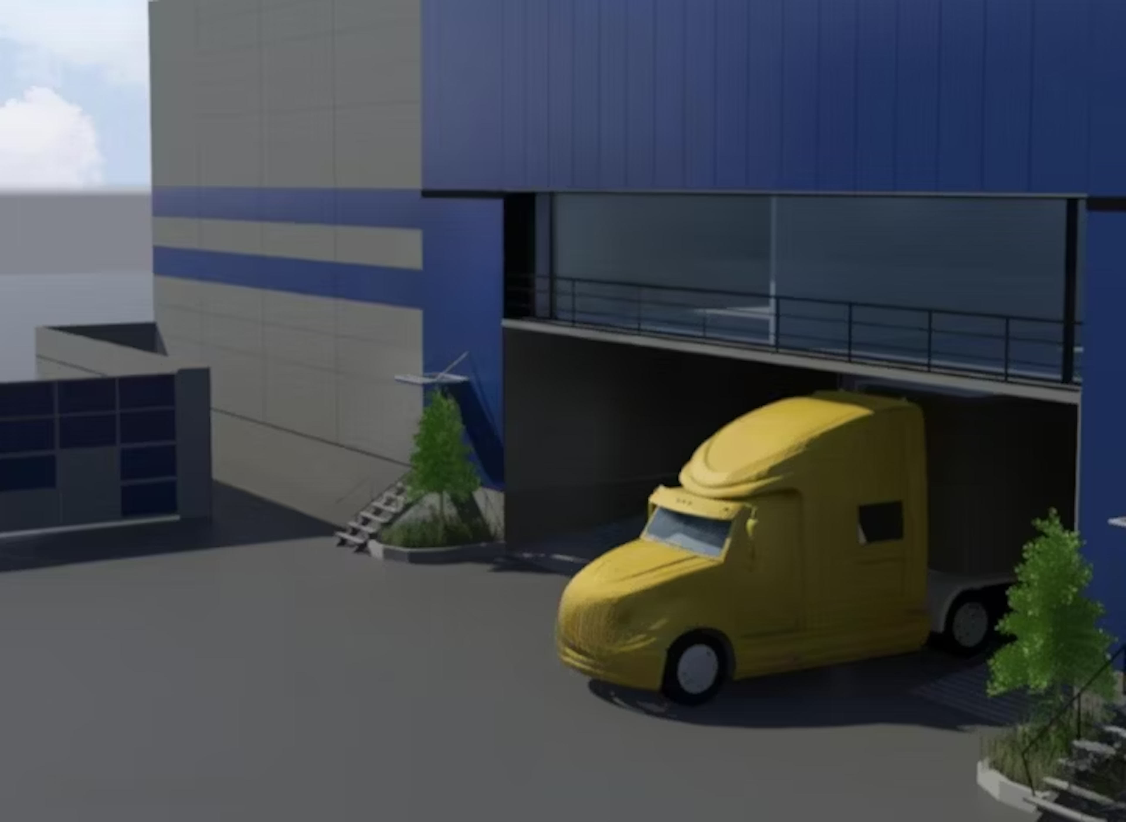 La imagen muestra un edificio industrial moderno con fachadas azules y grises. En primer plano se ve un camión de reparto amarillo brillante estacionado frente al edificio. El complejo tiene múltiples niveles, con una pasarela elevada visible. Hay pequeñas áreas verdes con árboles alrededor del edificio, lo que sugiere un diseño que integra elementos naturales en un entorno industrial o comercial.