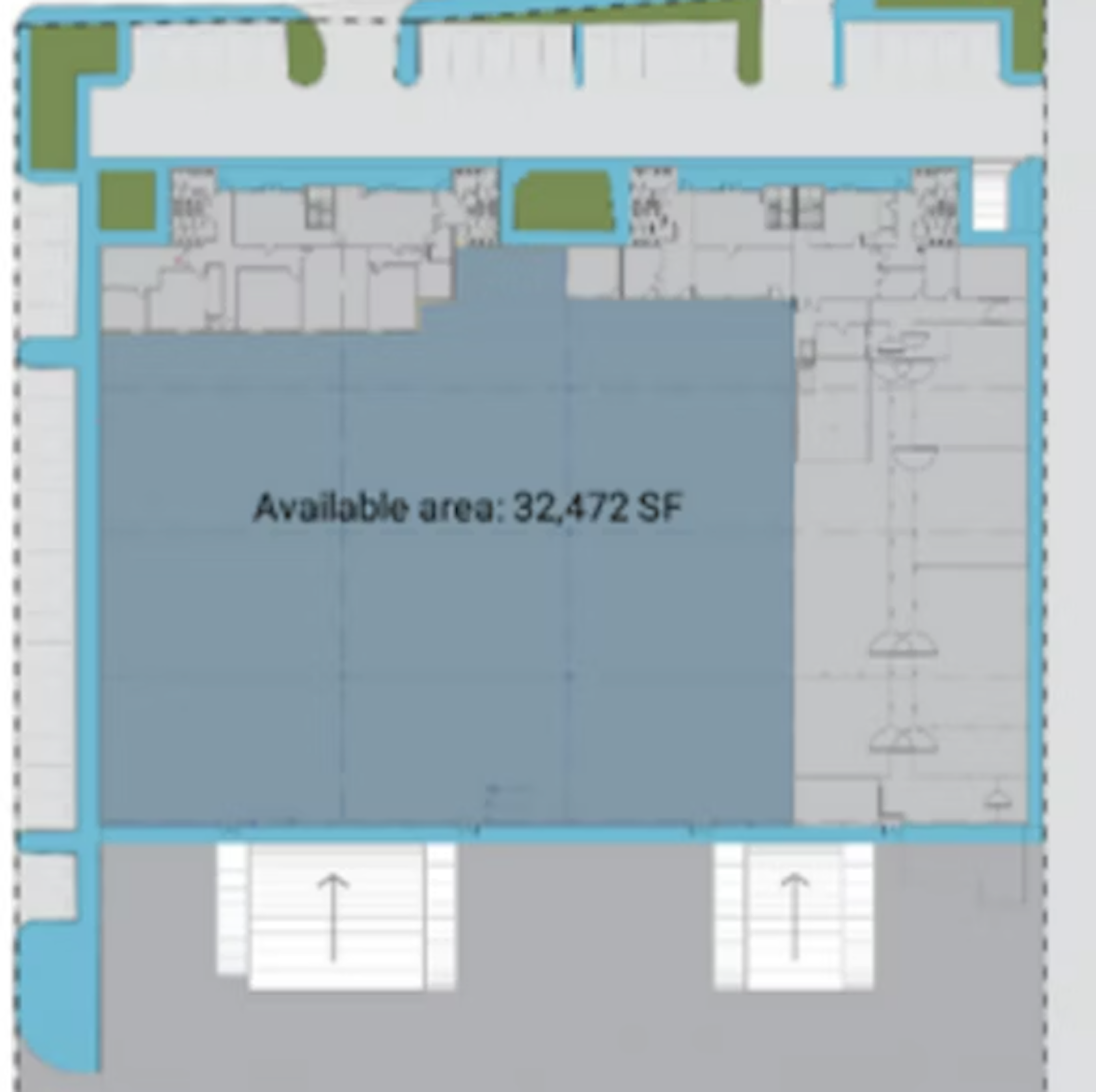 The image shows a floor plan for a large commercial or retail space. The available area is 32,472 SF, outlined in blue. The layout includes multiple rooms or sections around the perimeter, with a vast open central area. There are green spaces indicated, possibly for landscaping or outdoor areas. Two staircases are visible at the bottom of the plan. The design suggests a spacious, multi-purpose commercial property suitable for various business uses.